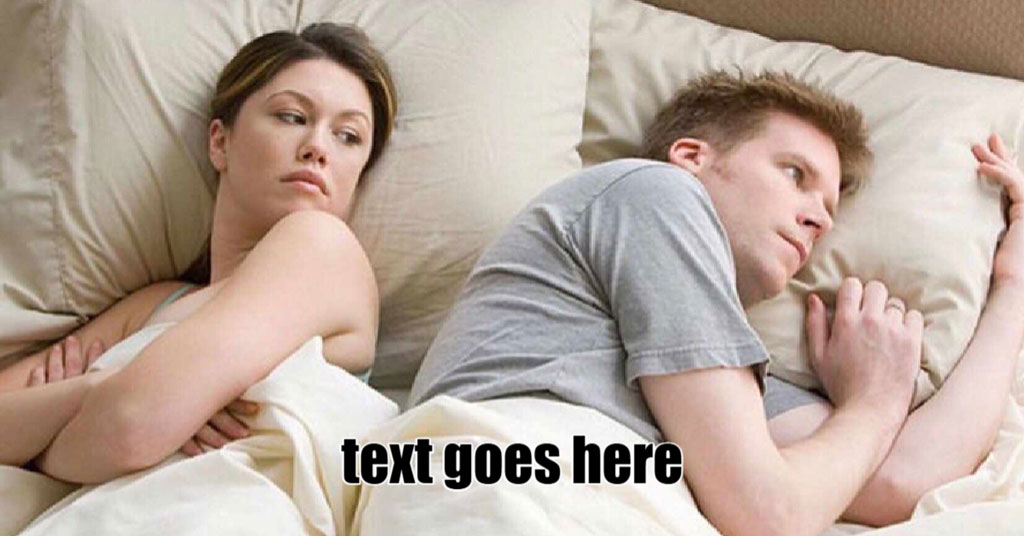 A woman lies awake next to a sleeping man in bed