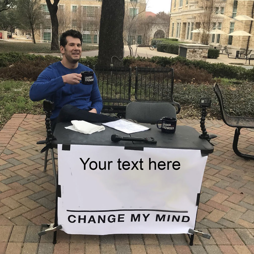 Man sitting at a table with a 'Change My Mind' sign
