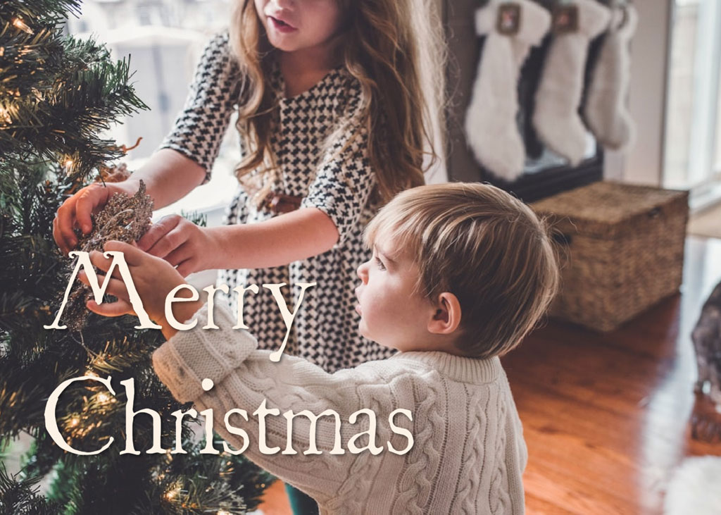 Children decorating Christmas tree together