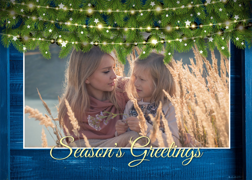 Two young girls in a field with a festive border