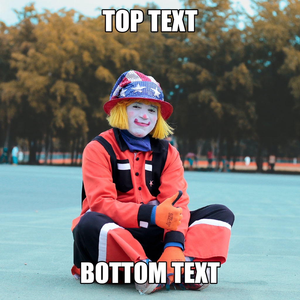 Clown sitting on the ground with a red jacket and orange gloves.