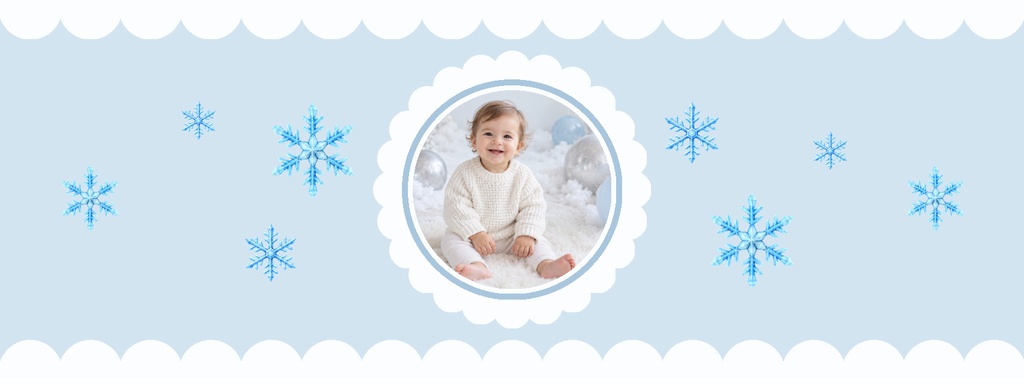 Light blue winter cover with snowflakes and a circular baby photo frame.