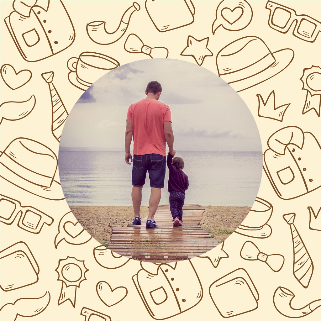 Man and child walking on a wooden dock towards the sea