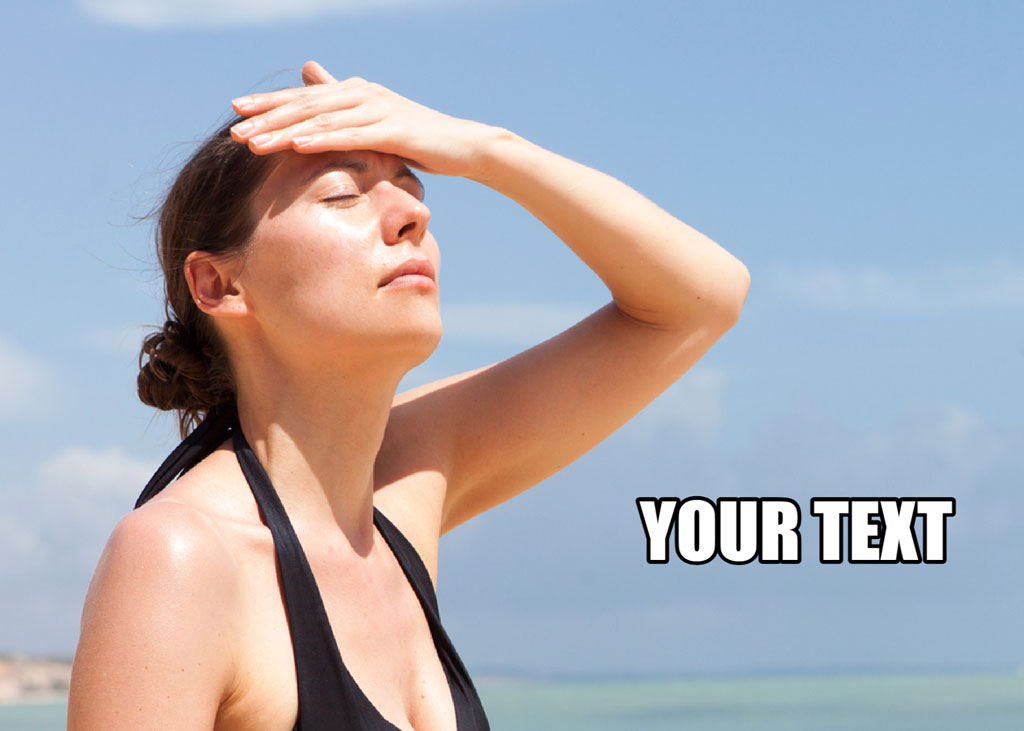 Woman in black swimsuit shielding eyes from sun