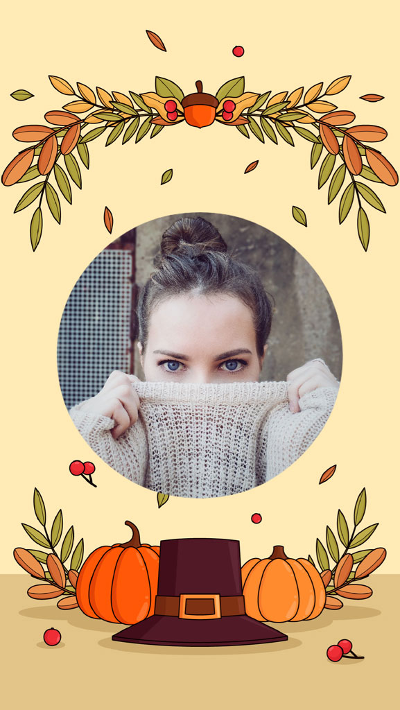 A woman in a beige sweater with blue eyes, surrounded by fall leaves and pumpkins.
