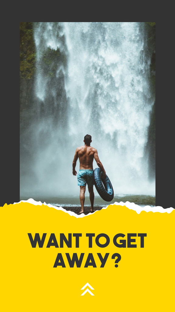 Man with an inner tube standing in front of a waterfall