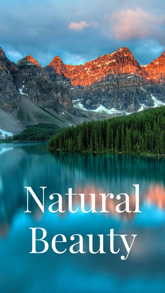 A serene lake surrounded by evergreen trees and majestic mountains under a blue sky