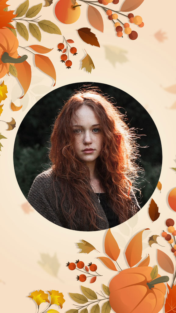 A woman with long red hair in a circular frame surrounded by autumn leaves and pumpkins.