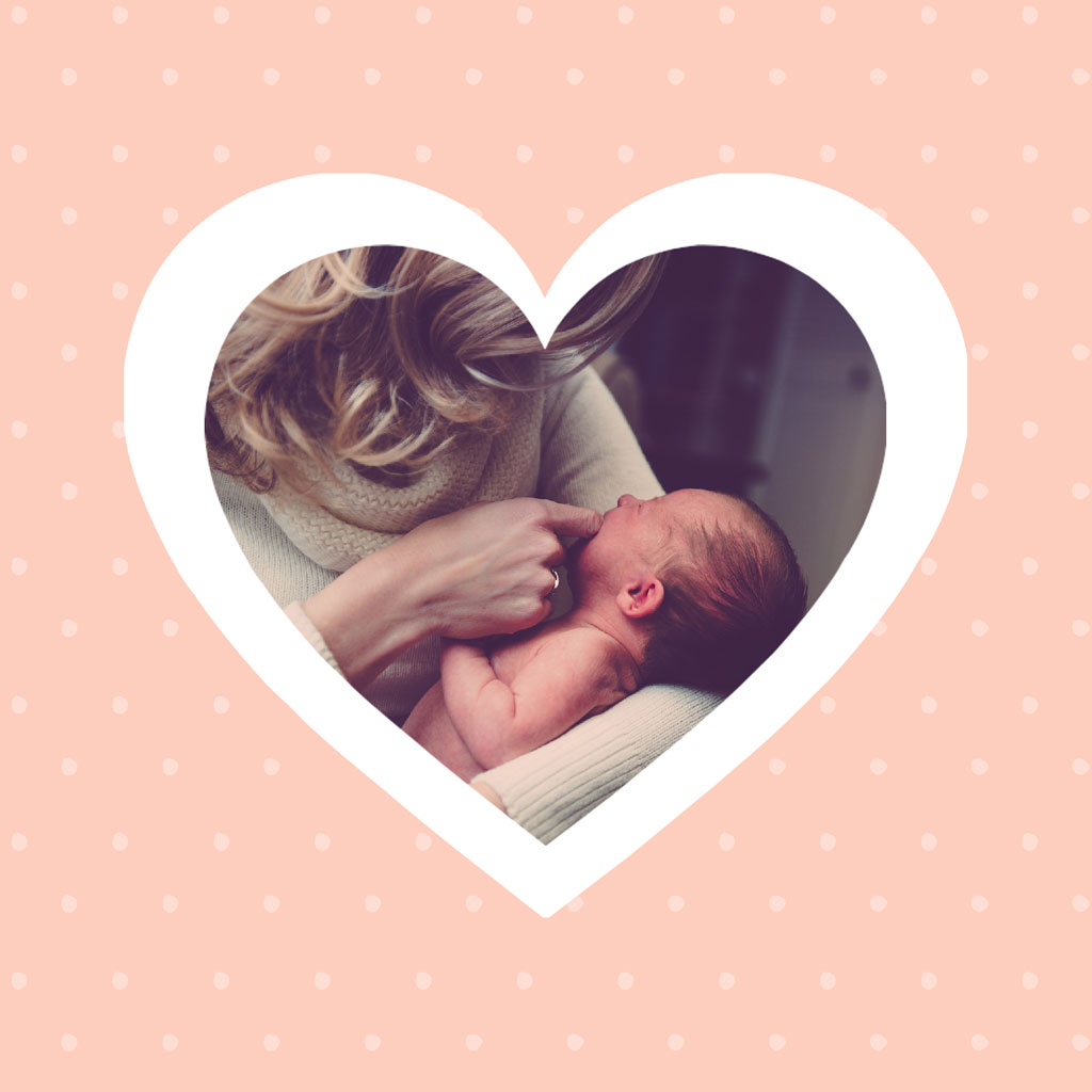Woman holding and kissing a newborn baby inside a heart-shaped frame