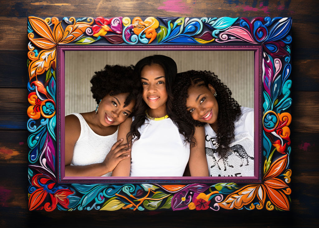 Three women in white tops posing in a colorful frame