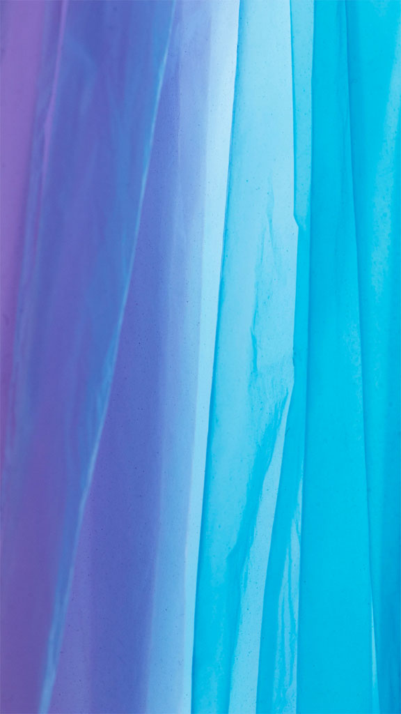 Close-up view of vibrant, flowing fabric in shades of purple and blue