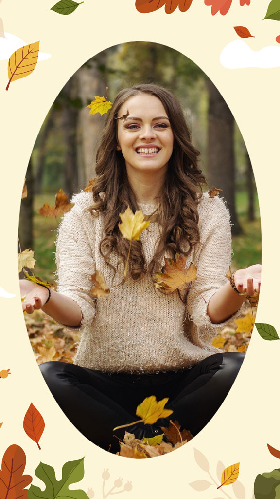 Woman meditating surrounded by autumn leaves