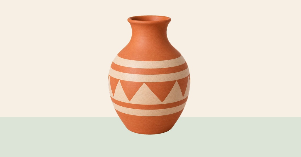 Terracotta vase with cream geometric bands on a pale background