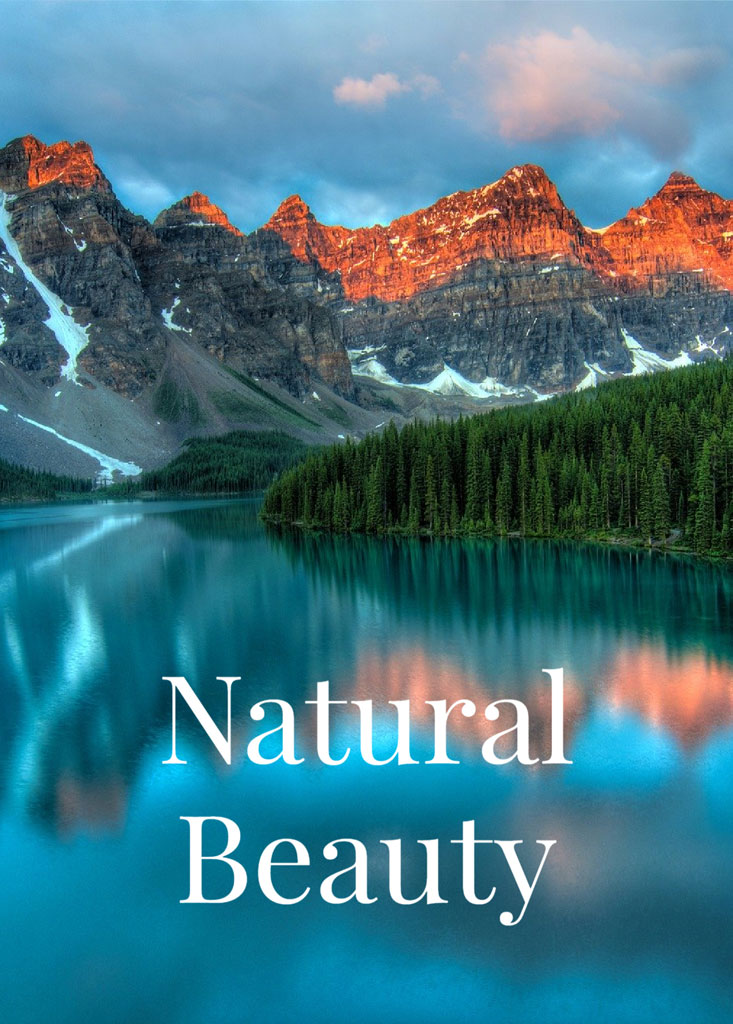 Mountain range with snow and trees reflected in a calm lake