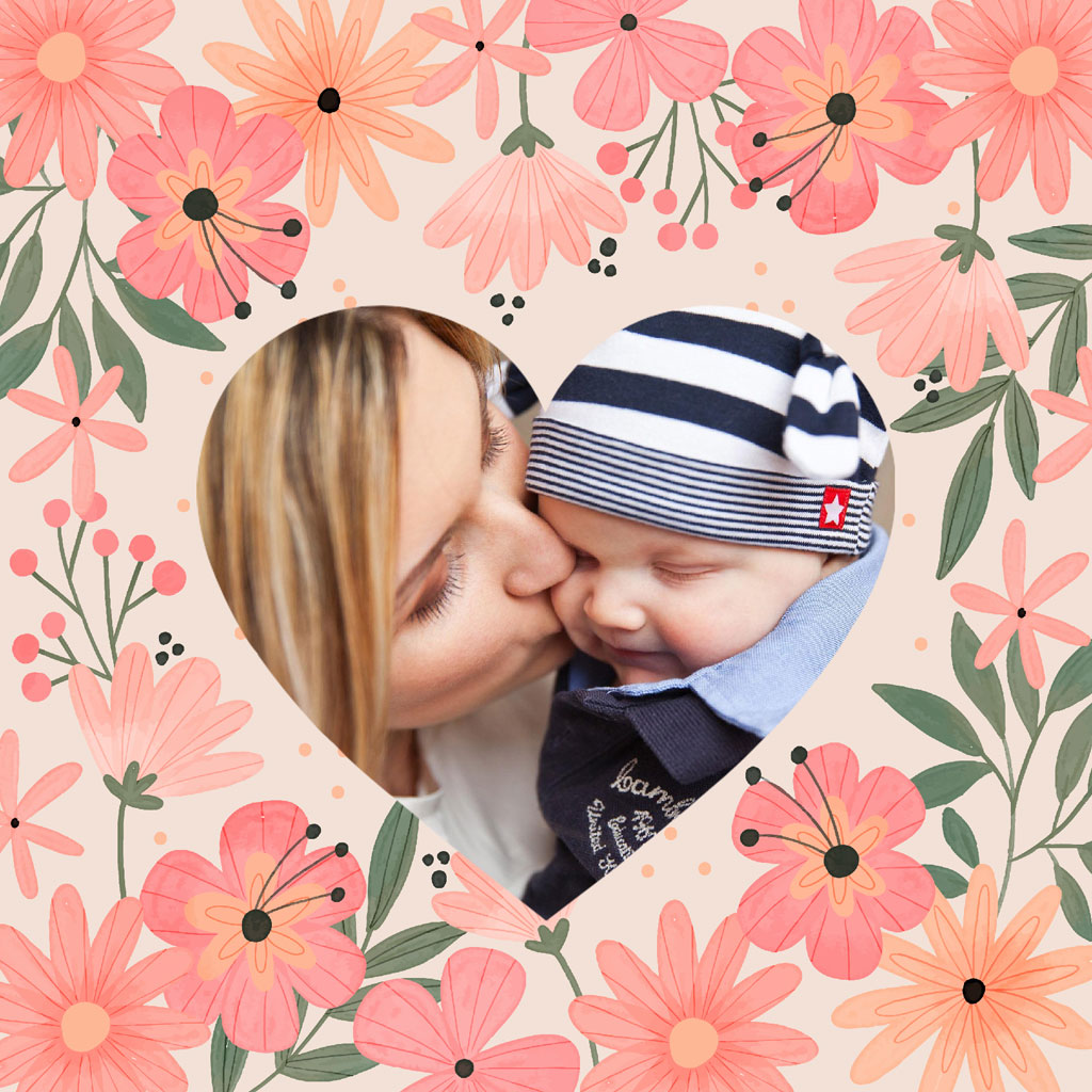 A mother kissing her baby's forehead, surrounded by pink flowers and a heart-shaped frame.