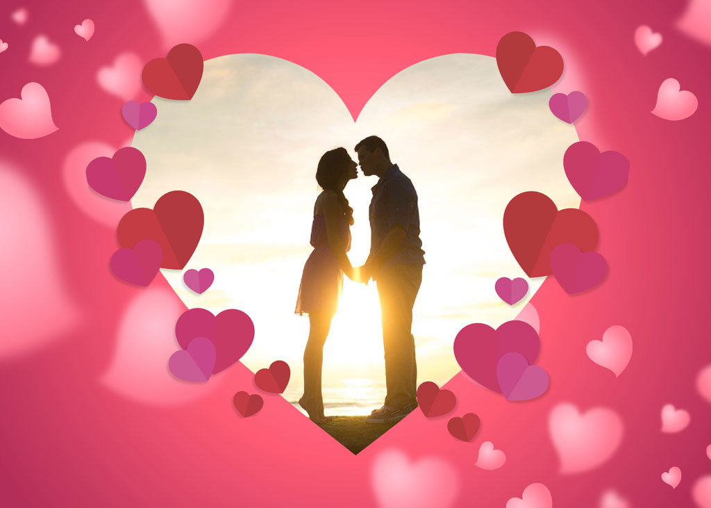 Couple kissing in a heart-shaped frame with sunset background
